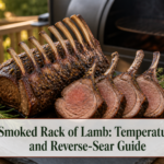 Carved smoked rack of lamb with browned herb crust and clean rib bones on a dark serving board