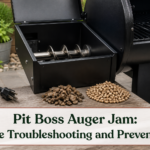Unplugged pellet grill hopper with dry pellets and a clean exposed auger assembly prepared for safe inspection